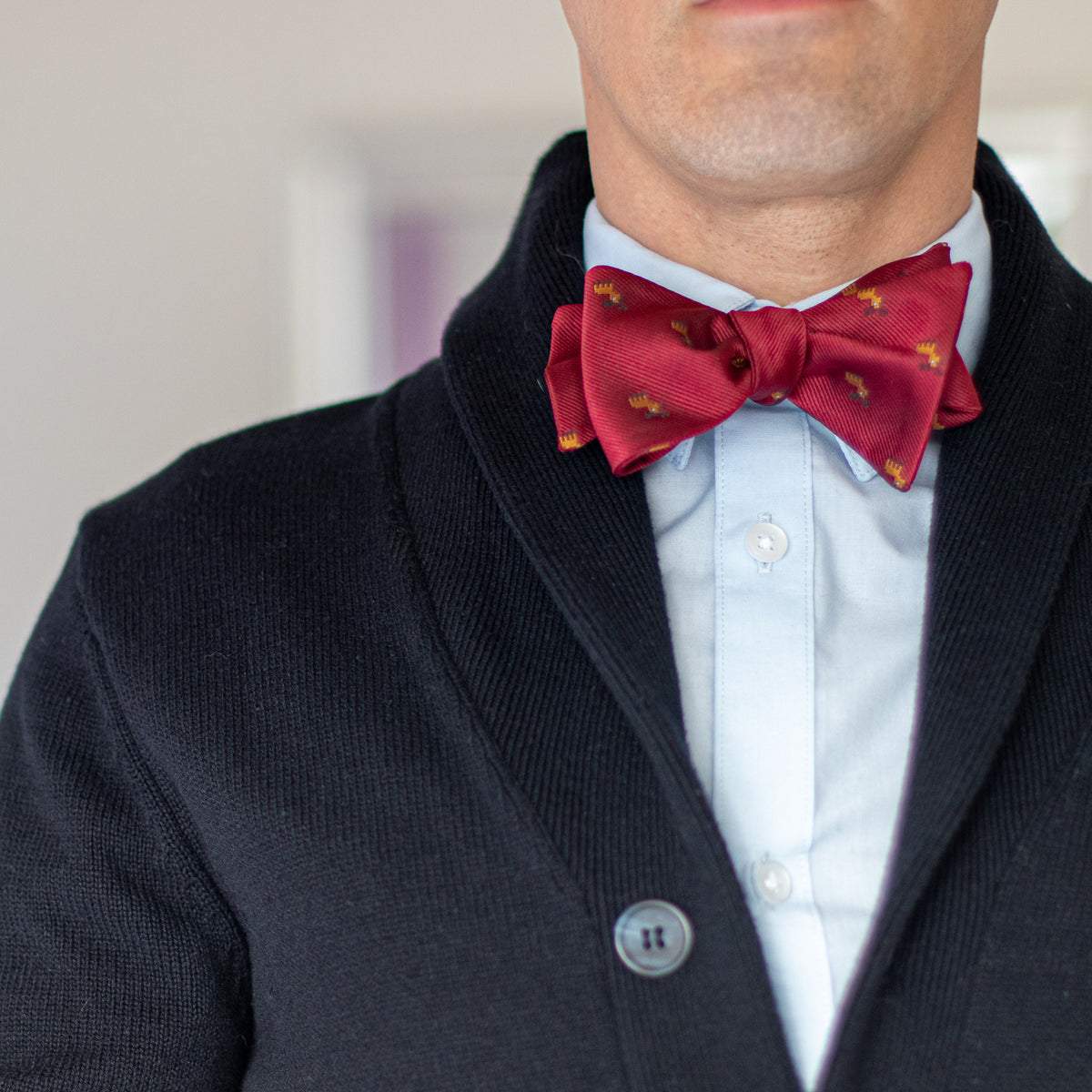 Red reindeer bow tie with navy blue sweater