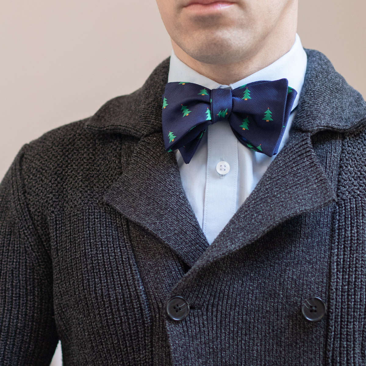 Navy blue Christmas tree bow tie with dark gray knit sweater