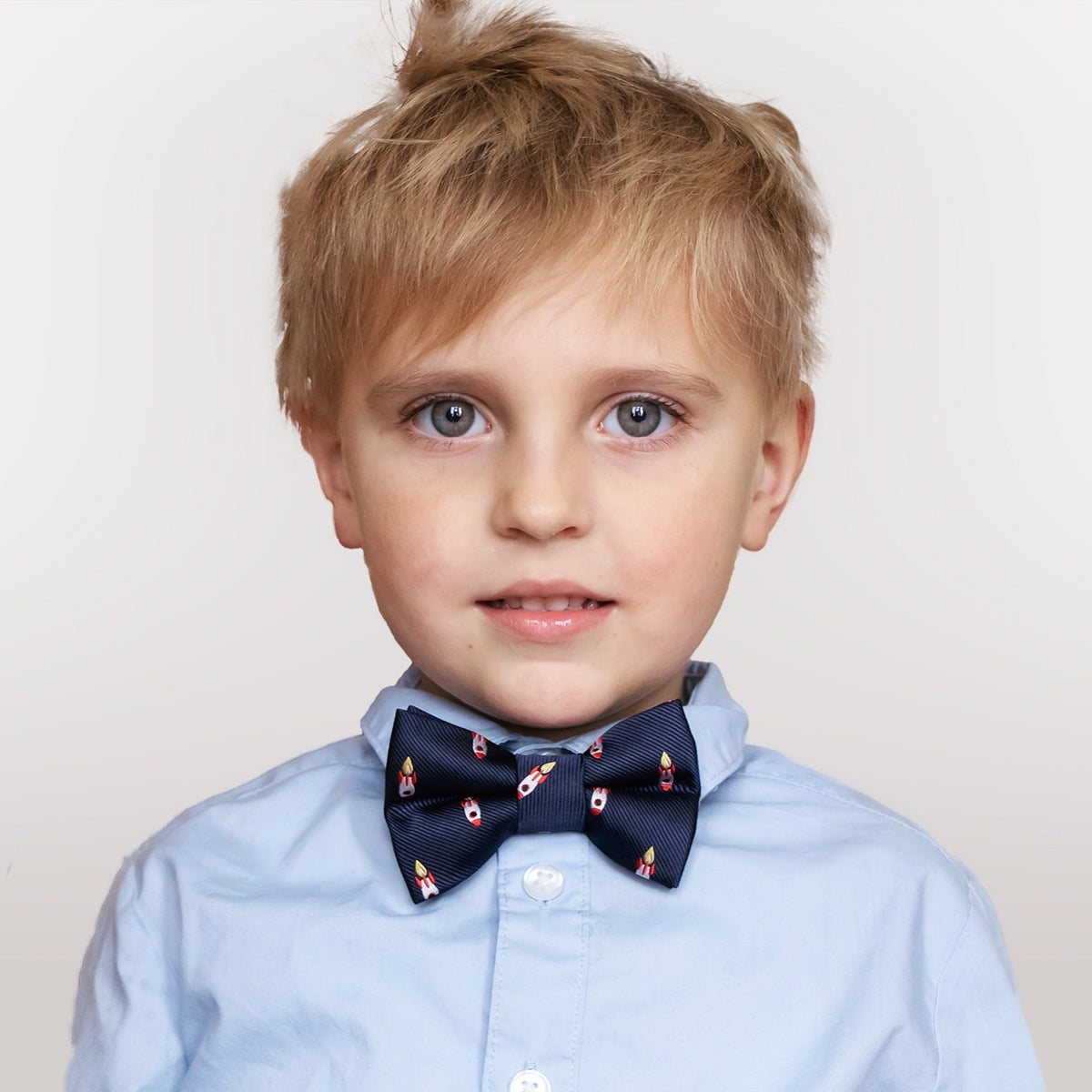 Rocket ship boys bow tie worn with blue button-down shirt