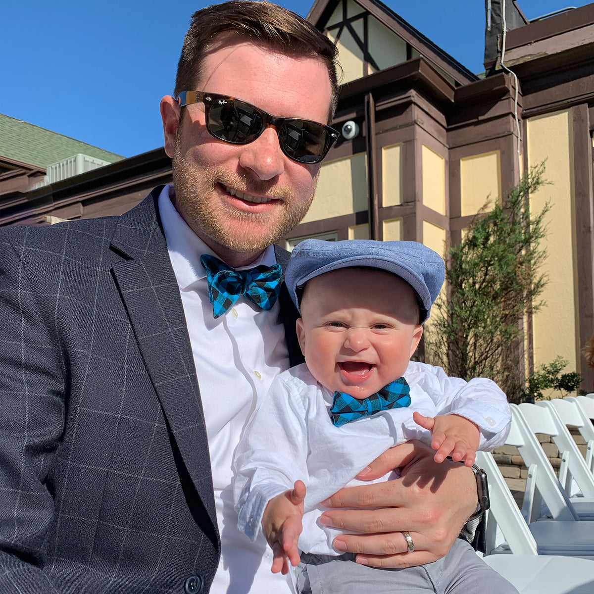 Father and son in matching blue plaid bow ties