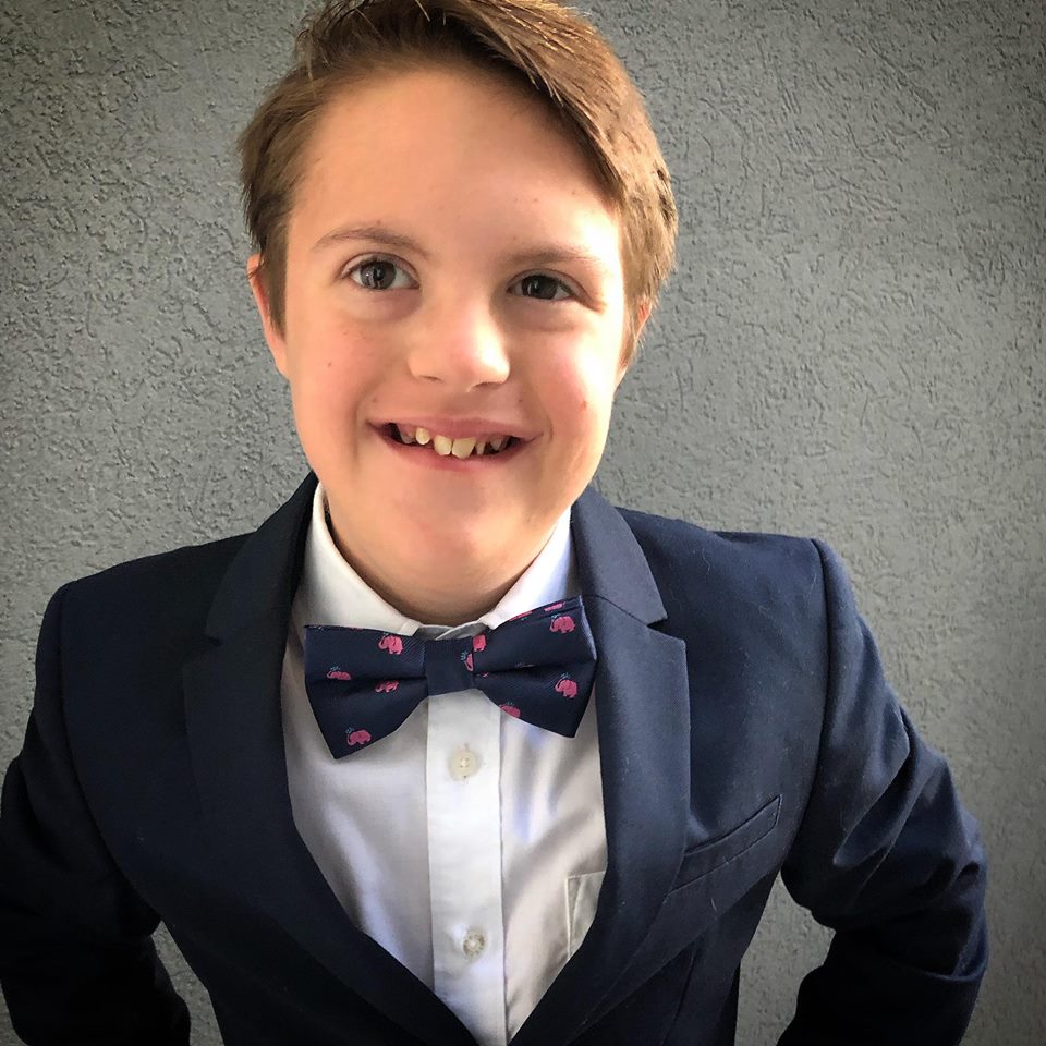 Boy wearing navy bow tie with pink elephants