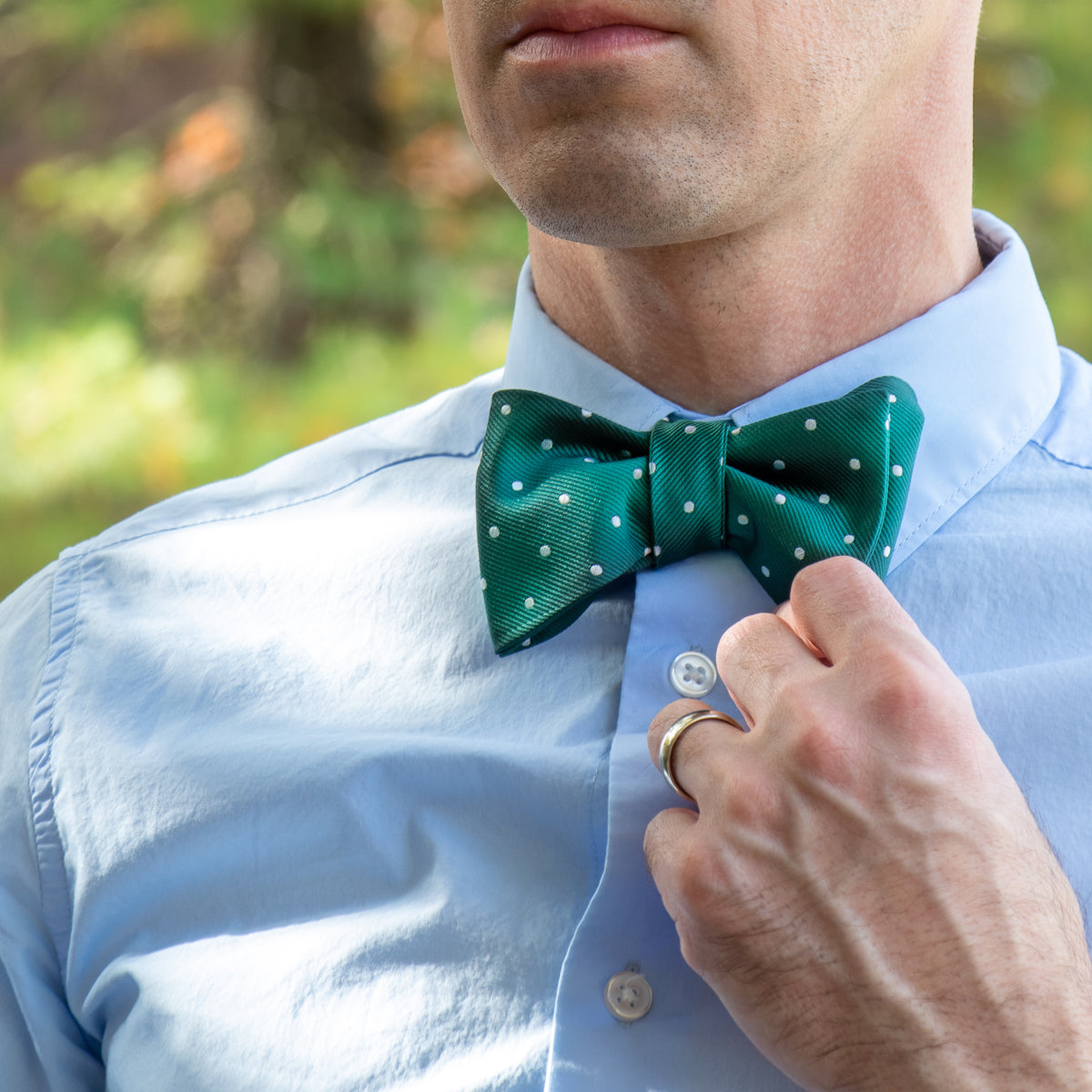 green and white polka dot bow tie with blue shirt