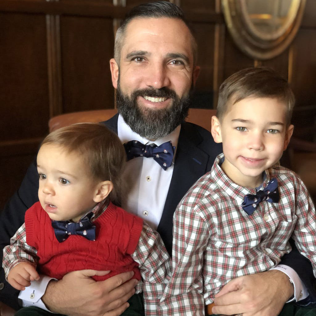 Dad and two boys wearing snow man bow ties